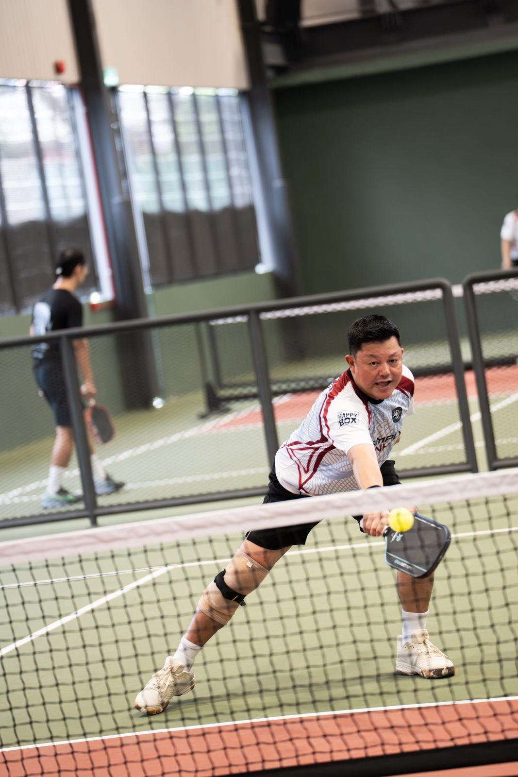 Simply Dink player reaching at the net, MPIC 2026
