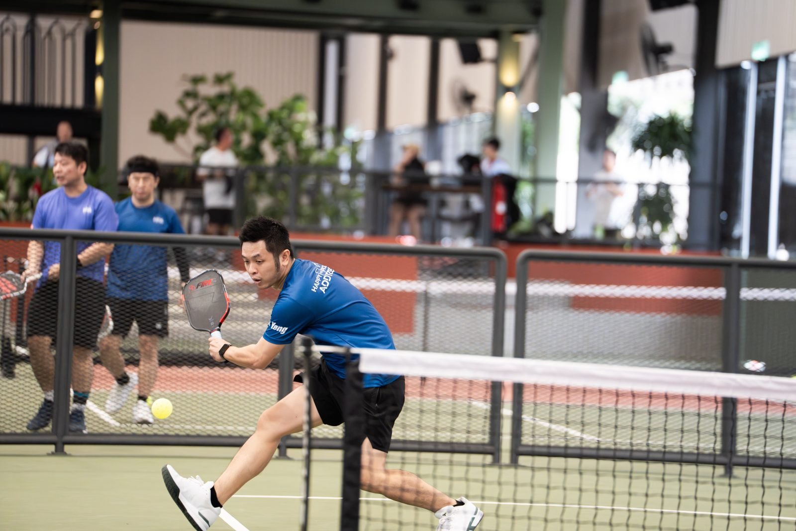 Happy Pickle Addicters player leaping for a forehand, MPIC 2026